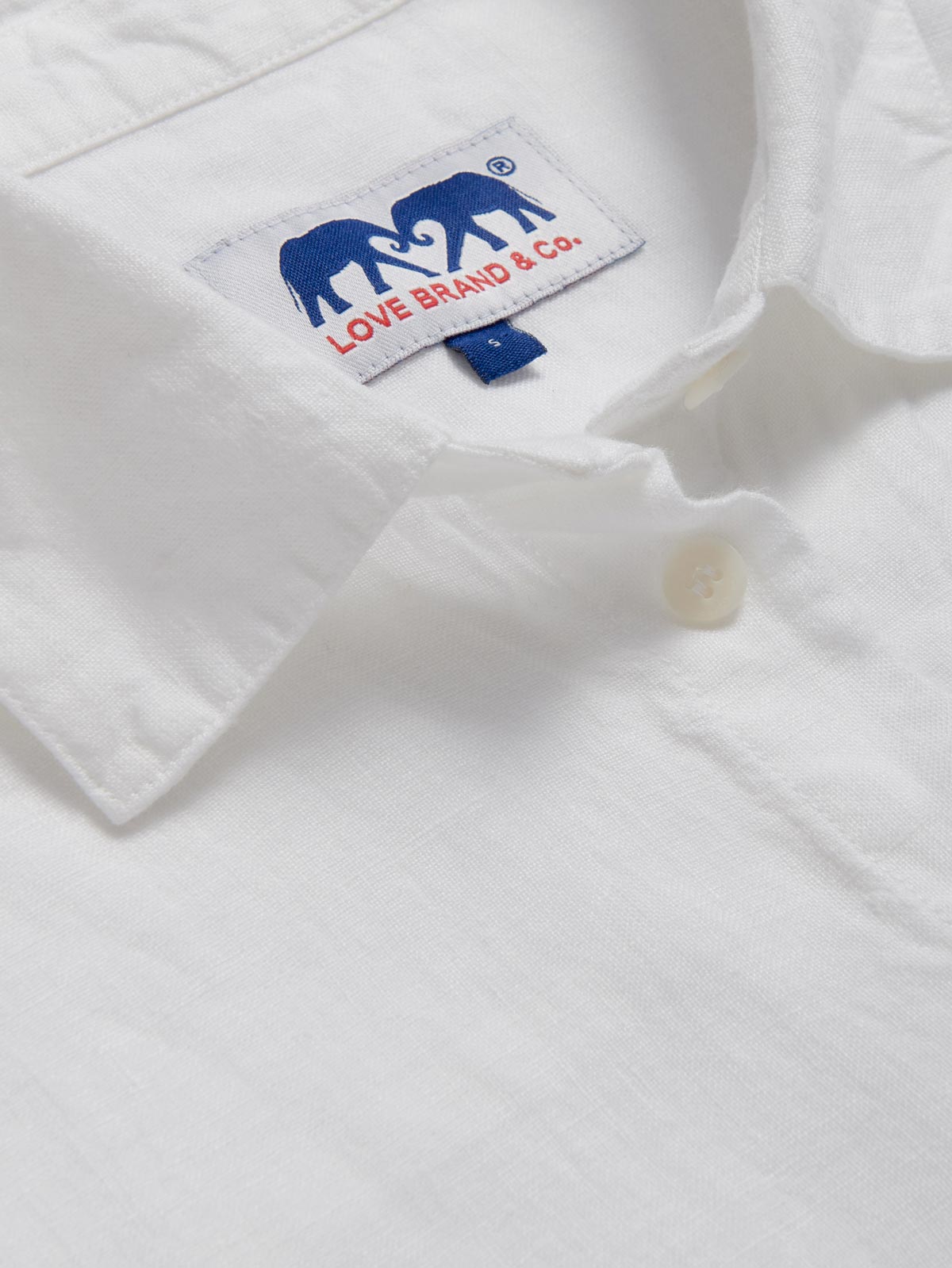 Detailed view of Womens White Inagua Linen Shirt. Long-sleeved button-up plain linen shirt with front pocket.