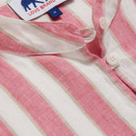 Detailed view of Womens Strawberries & Cream Jumento Linen Poncho. Half-button up, short-sleeved linen poncho in a white and pink striped pattern. Picture showcases white corozo nut buttons and love brand label.