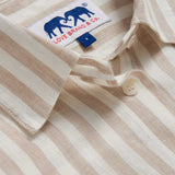 Close-up view of Womens Coconut Stripe Inagua Linen Shirt. Long-sleeved button-up 100% linen shirt with front pocket. Brown and white striped patterned all over.