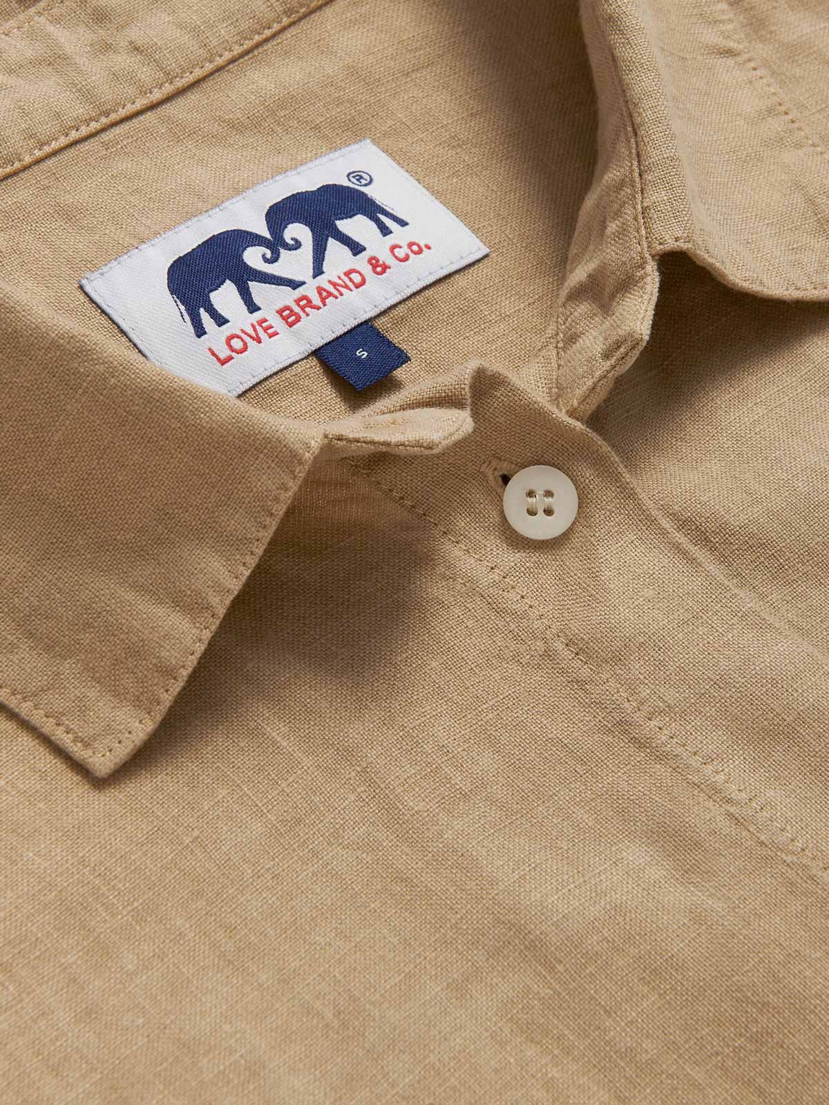 Detailed view of Womens Coconut Inagua Linen Shirt. Long-sleeved brown linen shirt with button-up design and front pocket. Crafted from 100% linen.