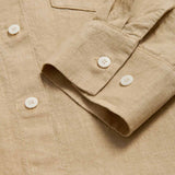 Beige midaxi linen shirt dress for women with long sleeves and a front pocket. Close-up view of cuff and linen fabric.