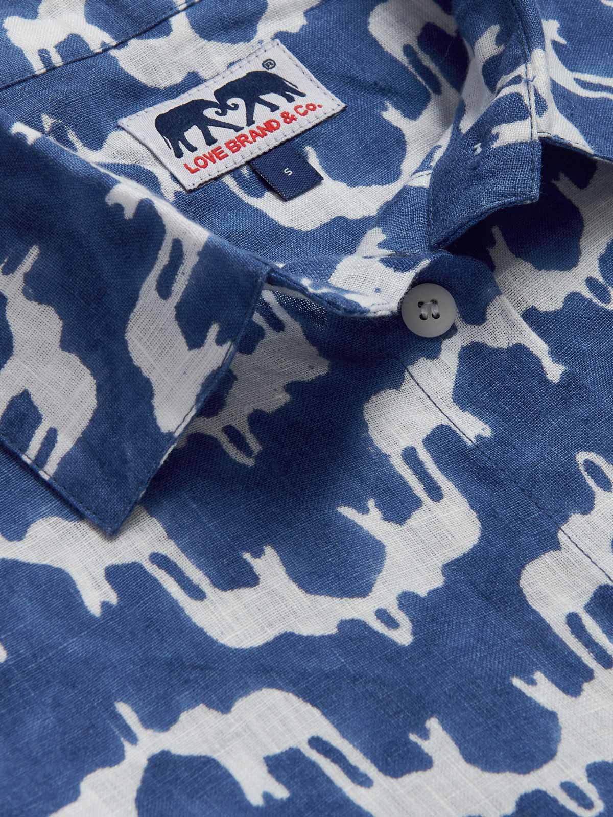 Close-up view of Womens Elephant Palace Blue Inagua Linen Shirt. Long-sleeved button-up linen shirt with front pocket. Blue and white shirt in our bestselling elephant palace blue print.