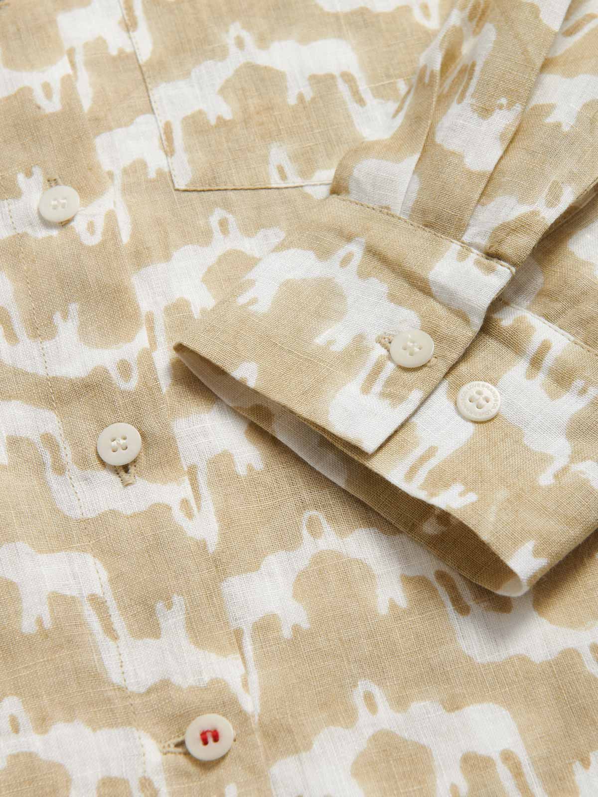 Close-up view of Womens Elephant Palace Coconut Inagua Linen Shirt. Brown and white elephant palace print long-sleeved shirt.