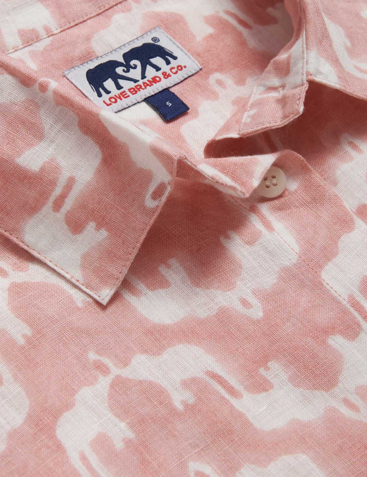 Close-up of our Womens Elephant Palace Strawberry Inagua Linen Shirt. Pink and white linen shirt with a handy front pocket. Finished with an allover elephant print.