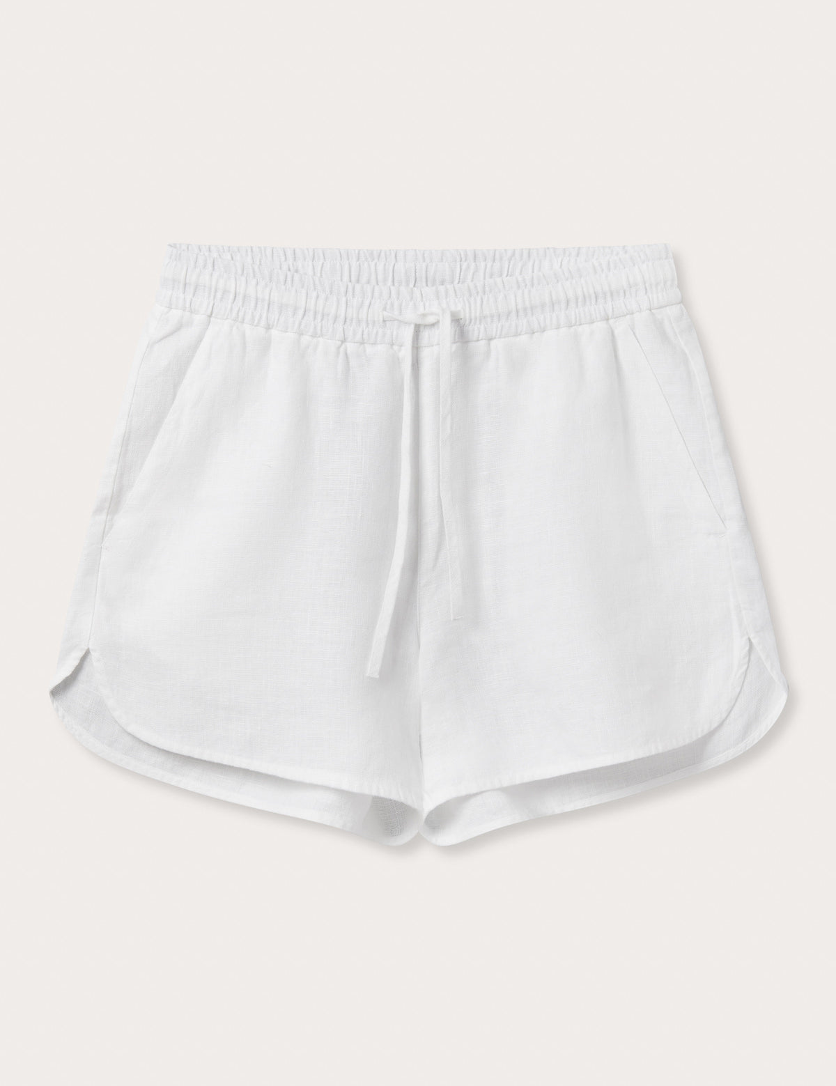 Front view of Womens White Musha Linen Shorts. 100% linen shorts in a relaxed fit with 2 front pockets. Featuring an elastic drawstring waist.