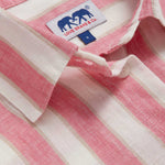 Close-up view of Womens Strawberries & Cream Sapodilla Linen Shirt Dress. Pink and white striped dress with long sleeves, a front pocket and button up design.