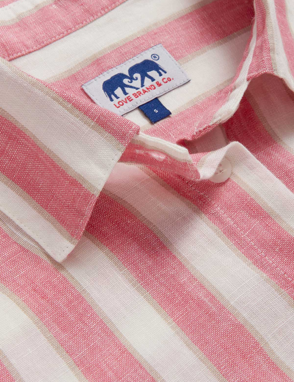 Close-up view of Womens Strawberries & Cream Sapodilla Linen Shirt Dress. Pink and white striped dress with long sleeves, a front pocket and button up design.