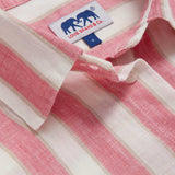 Close-up view of Womens Strawberries & Cream Sapodilla Linen Shirt Dress. Pink and white striped dress with long sleeves, a front pocket and button up design.