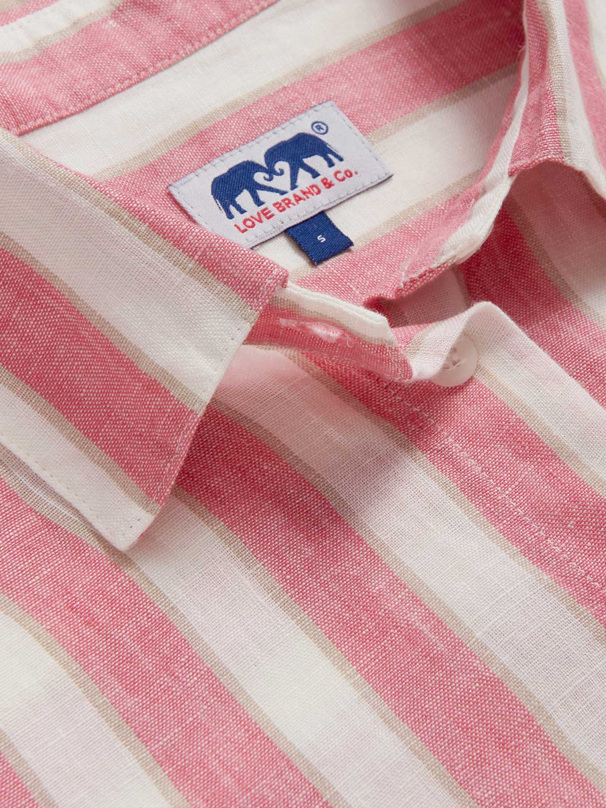 Close-up view of Womens Strawberries & Cream Sapodilla Linen Shirt Dress. Pink and white striped dress with long sleeves, a front pocket and button up design.