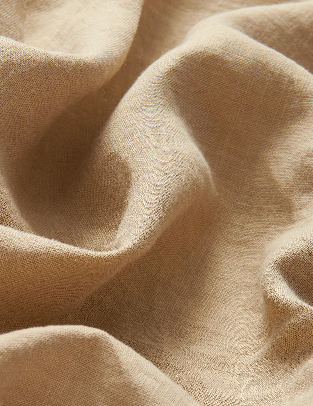 Close-up view of 100% line fabric of Womens Coconut Musha Linen Shorts. Beige linen shorts with 2 front pockets and drawstring waist in a relaxed fit. 