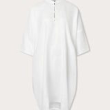 Front view of Womens White Jumento Linen Poncho. Half button-up short sleeved white poncho made from 100% linen.