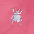 White beetle design on a pink background