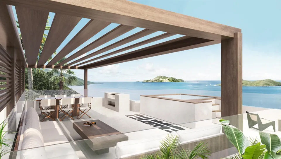 Modern outdoor patio with wooden pergola, dining table, and ocean view at Biras Creek