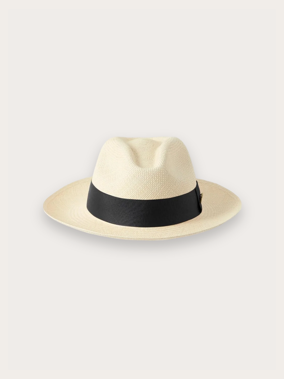 A light beige straw fedora hat with a black band around the crown, photographed against a solid light gray background.