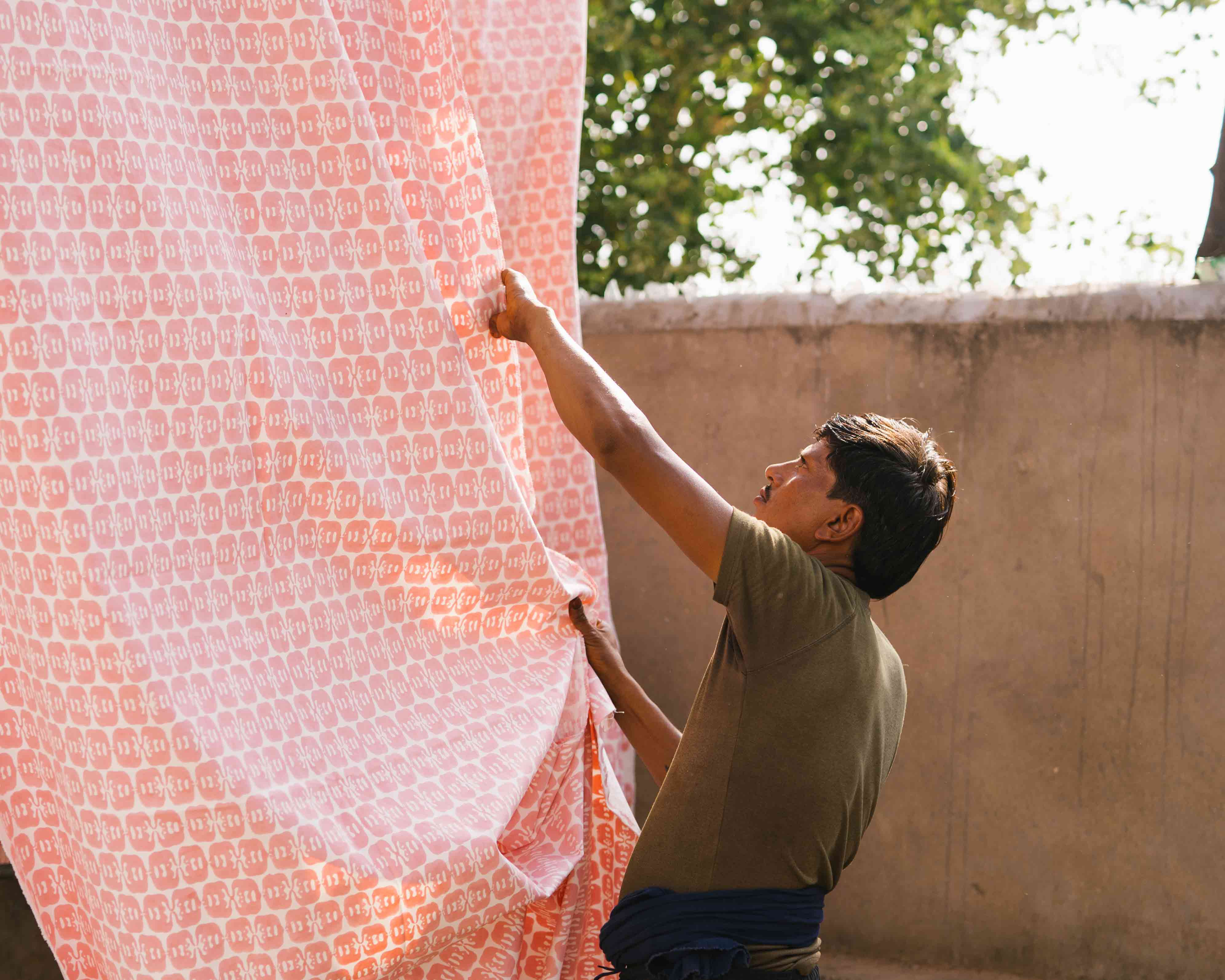 Love brand Elephants of India block print being hung out to dry by artisan.