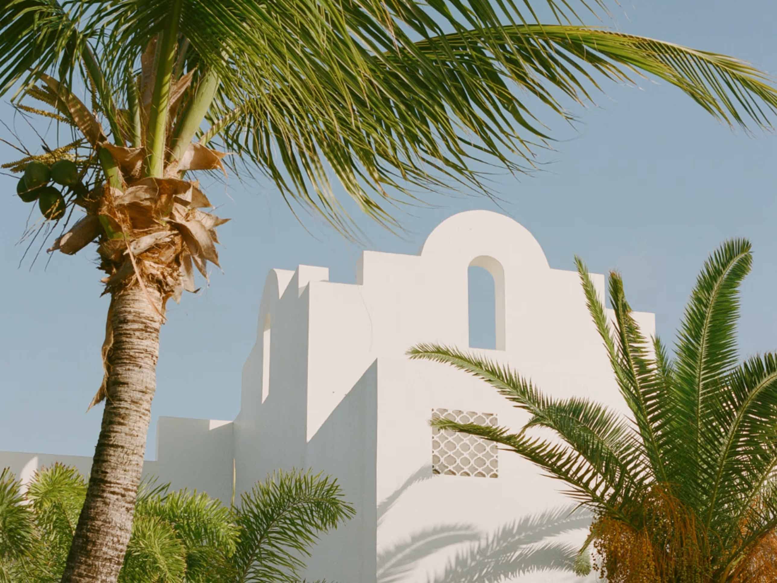 View of Cap Juluca exterior villa surrounded by palm trees