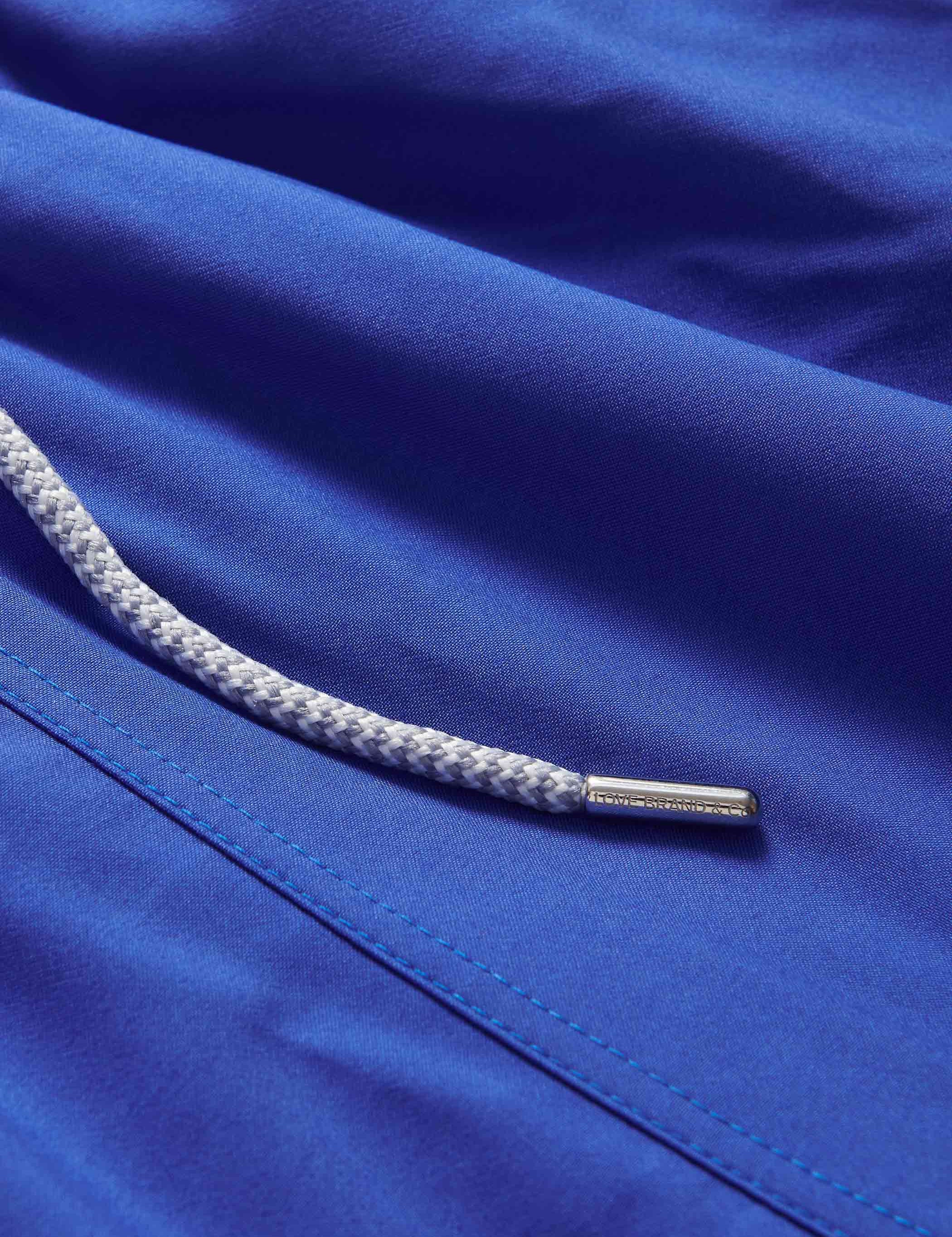 Close-up view of Boys Majorelle Blue Staniel Swim Shorts with drawstring.