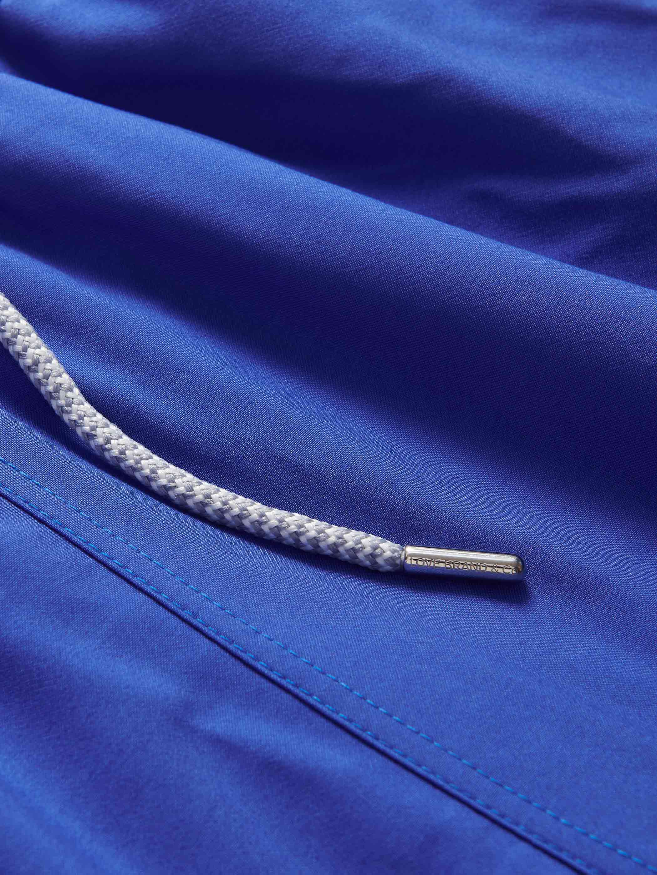 Close-up view of Boys Majorelle Blue Staniel Swim Shorts with drawstring.