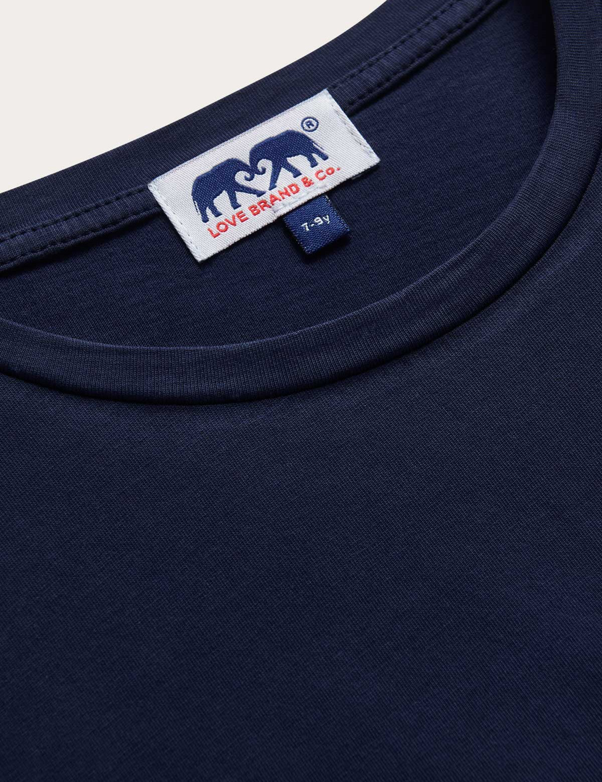 Detailed view of Kids Navy Blue Lockhart With Tab T-Shirt. Short sleeved blue t-shirt for children.