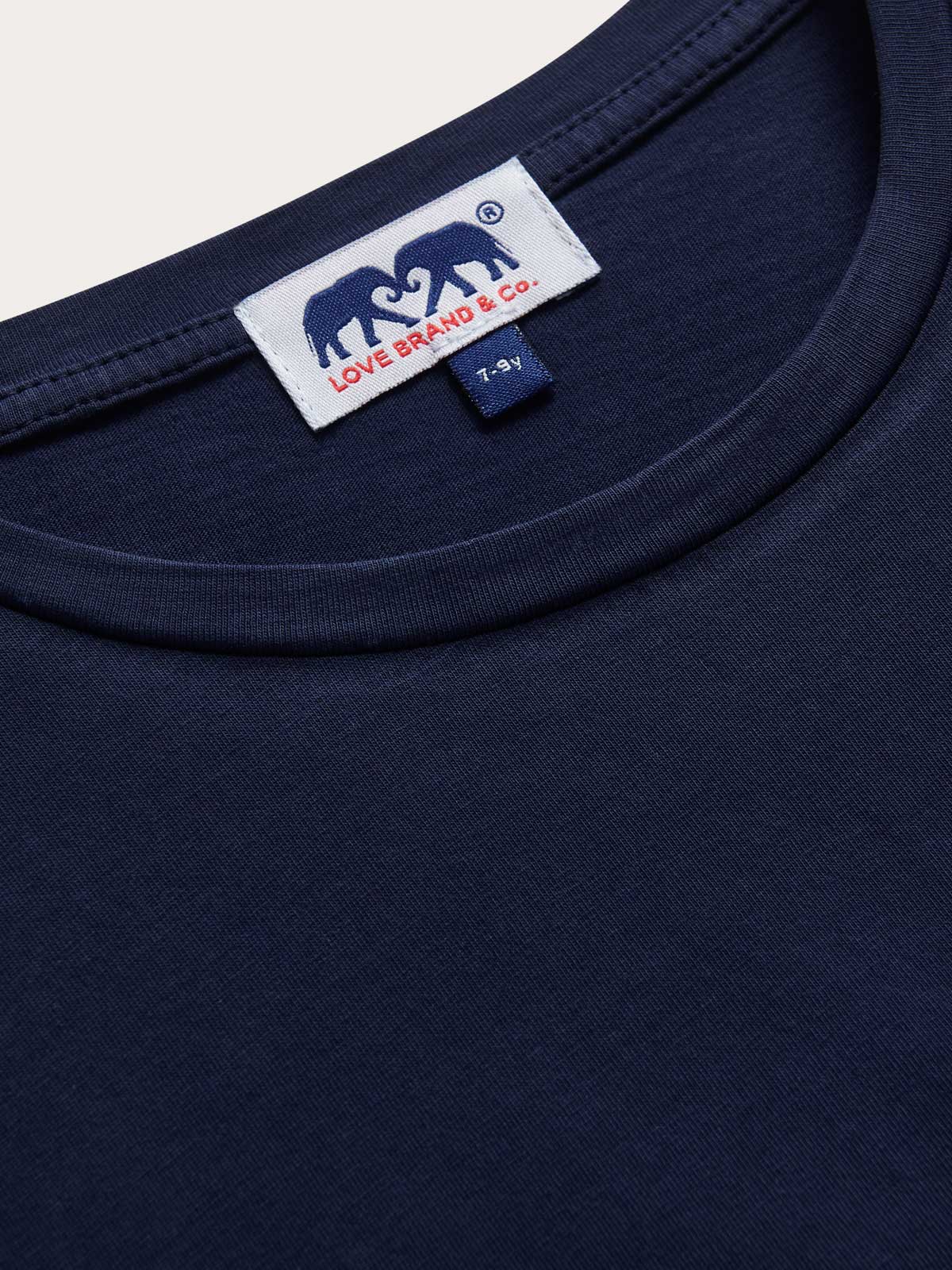 Detailed view of Kids Navy Blue Lockhart With Tab T-Shirt. Short sleeved blue t-shirt for children.