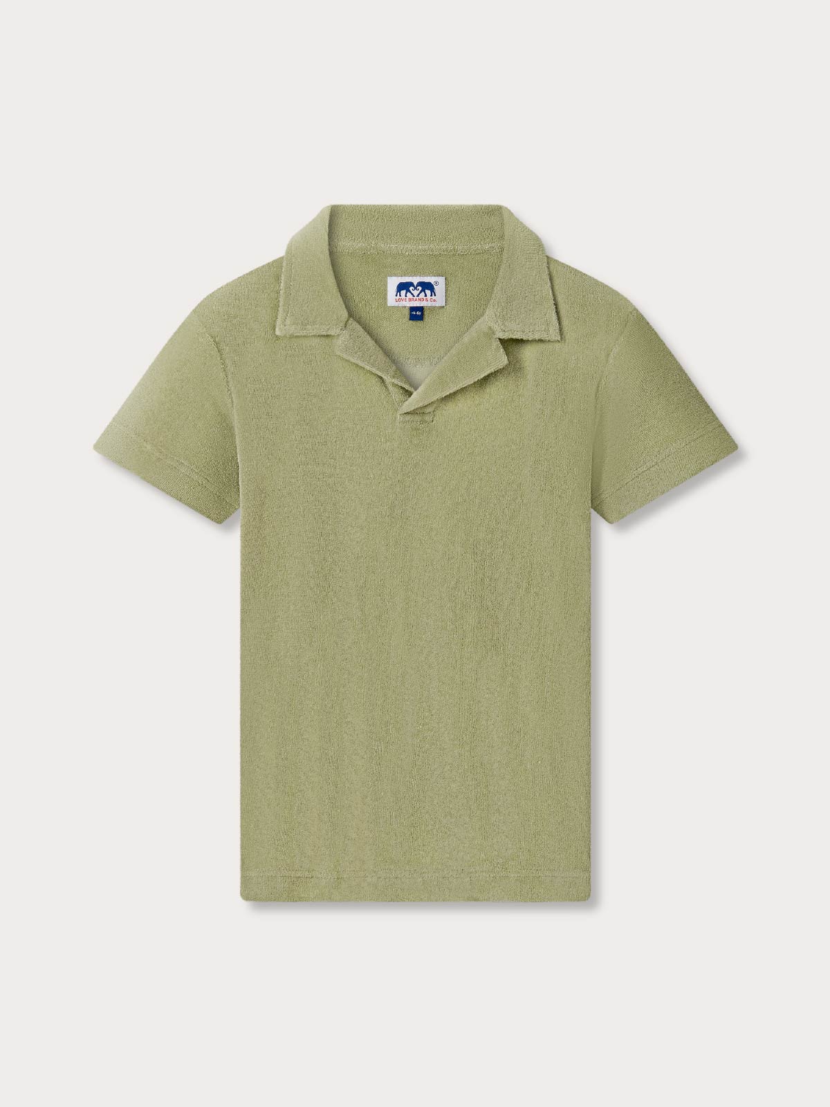 Front view of kids green terry polo shirt on a light grey background