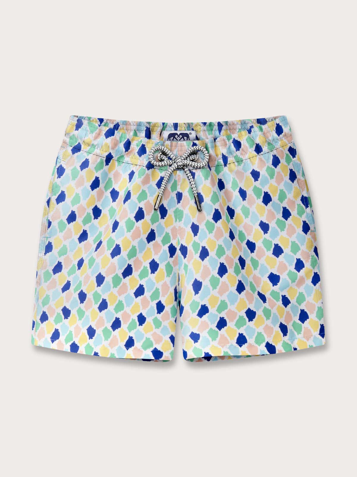 Colourful patterned swim shorts on a beige background