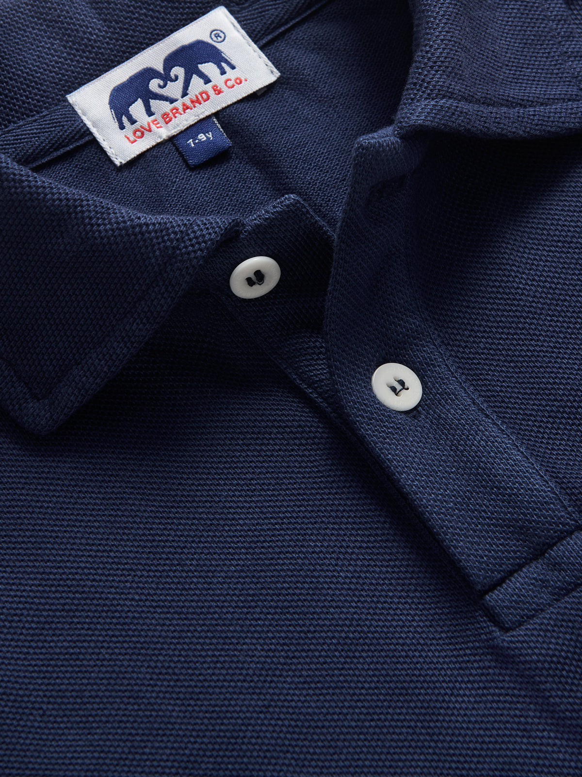 Close-up view of kids navy polo shirt by love brand