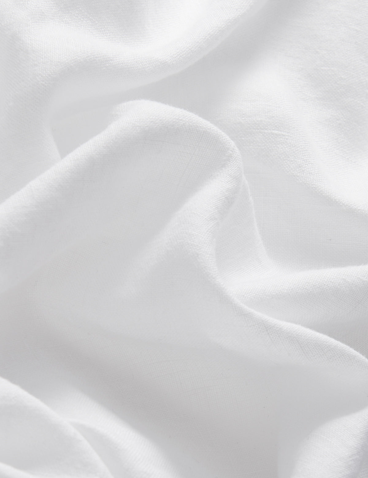 Detailed view of linen fabric of Kids White Joulter Linen Shorts.