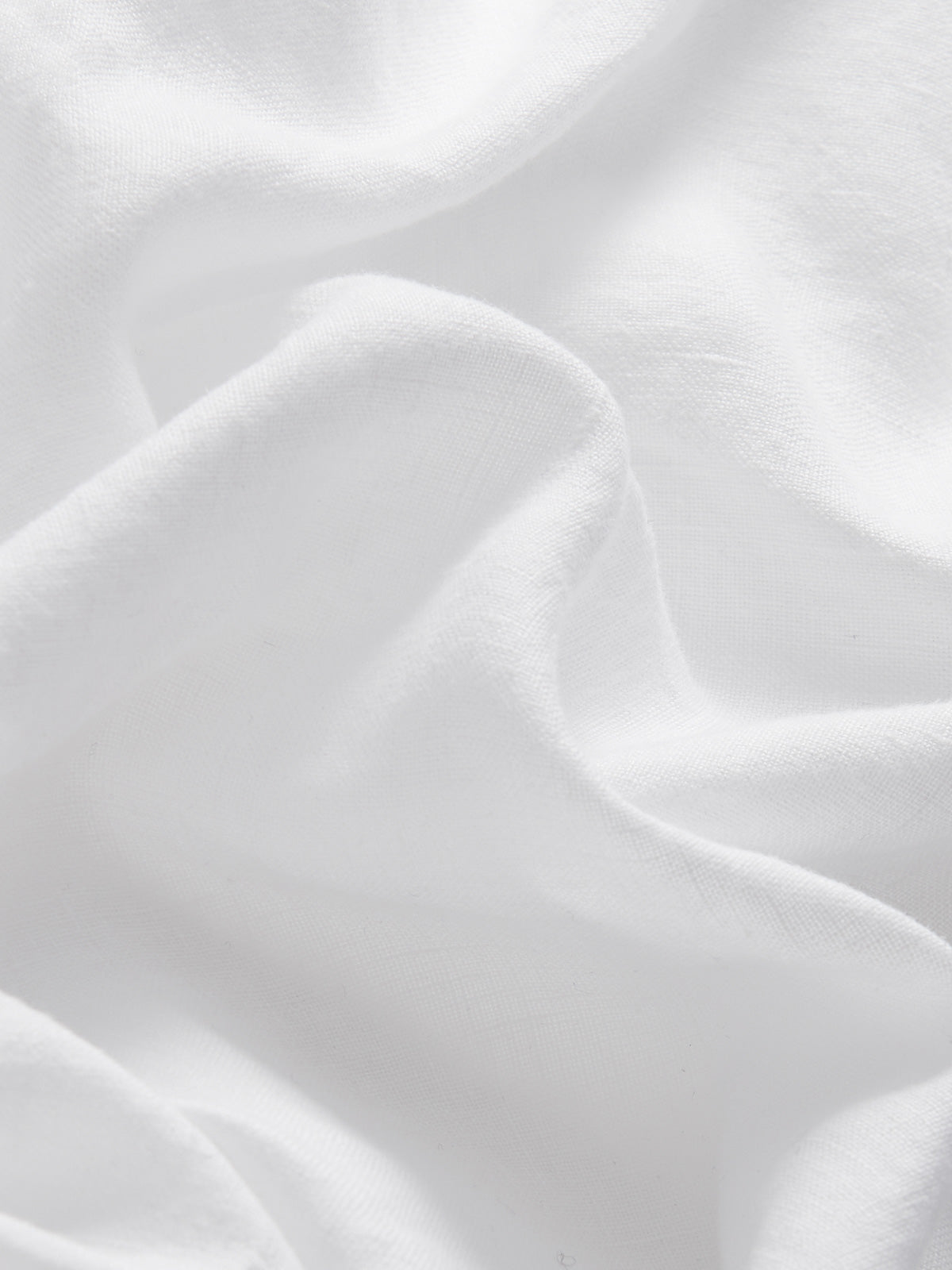 Detailed view of linen fabric of Kids White Joulter Linen Shorts.