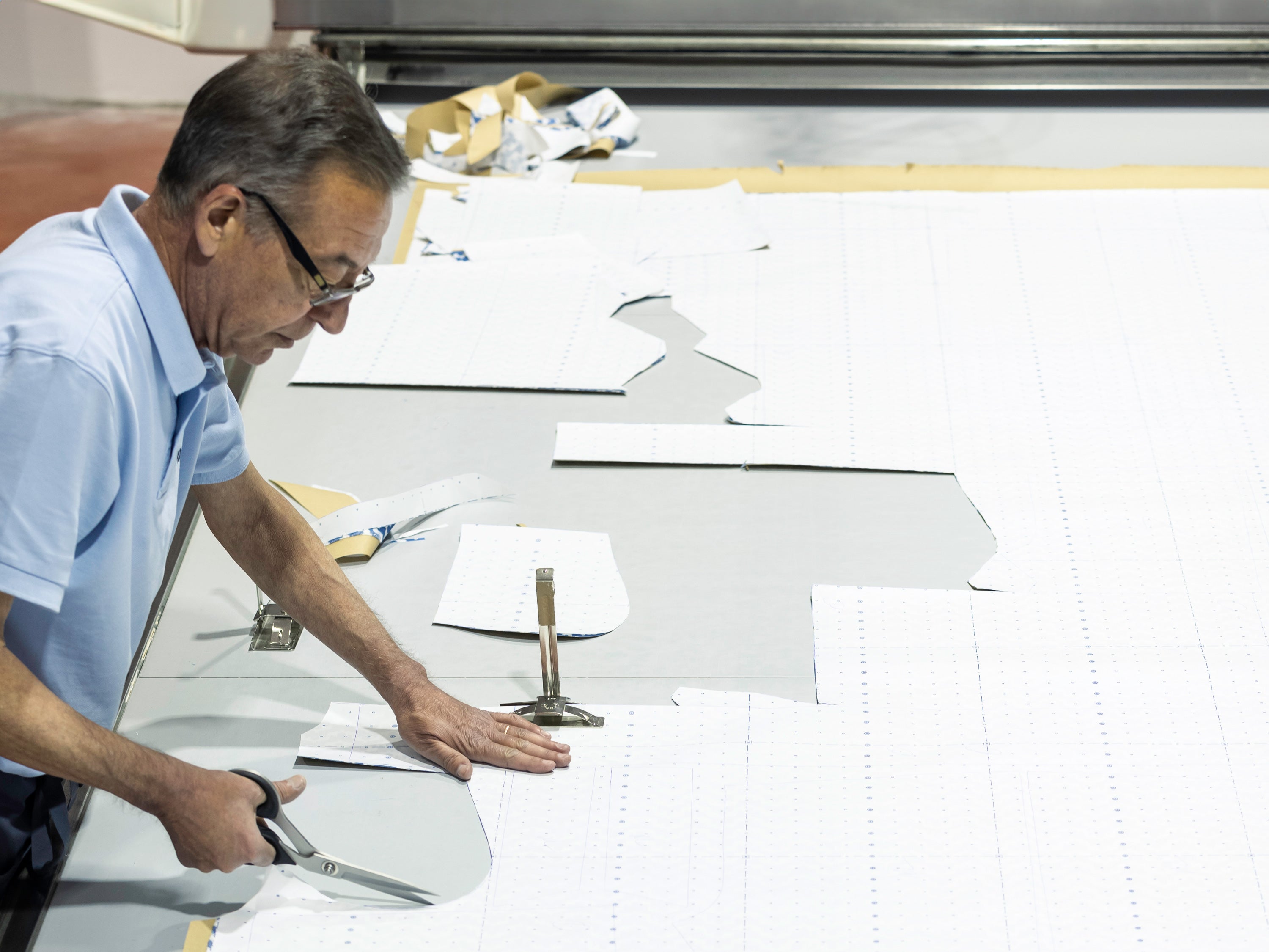 Man cutting swimming trunks patterns