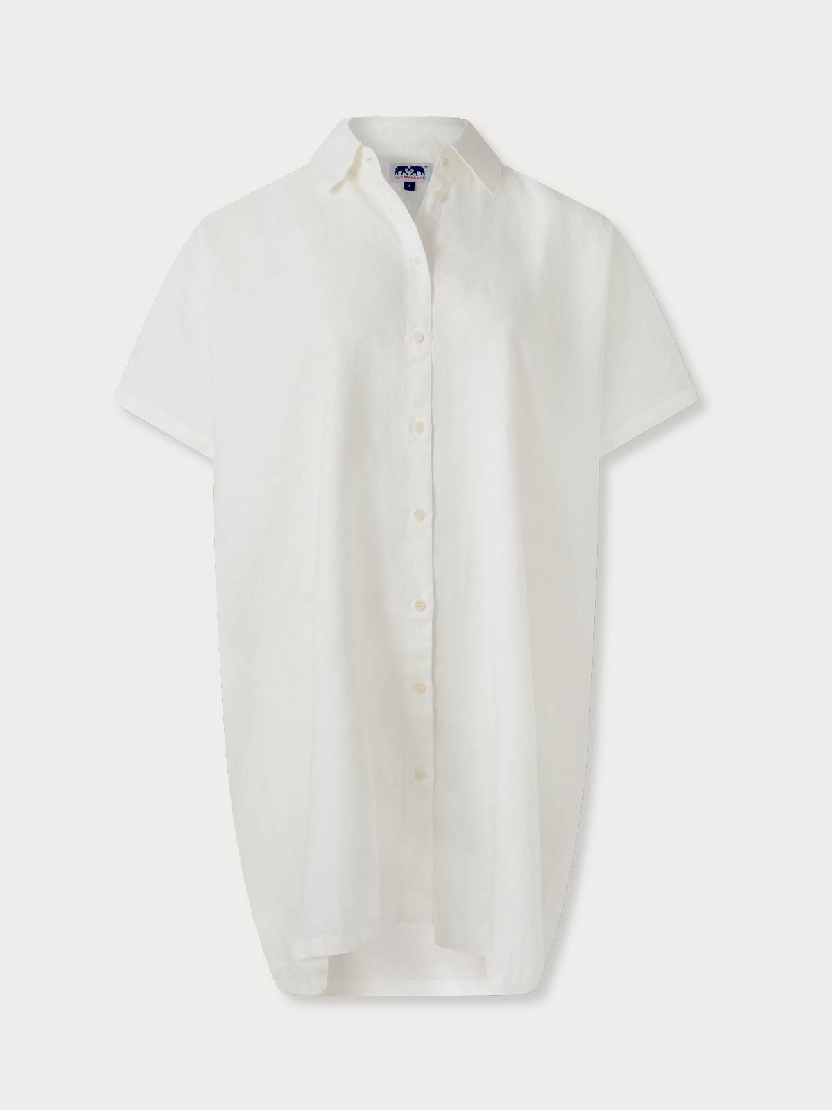 White short linen dress with short sleeves on a grey background.