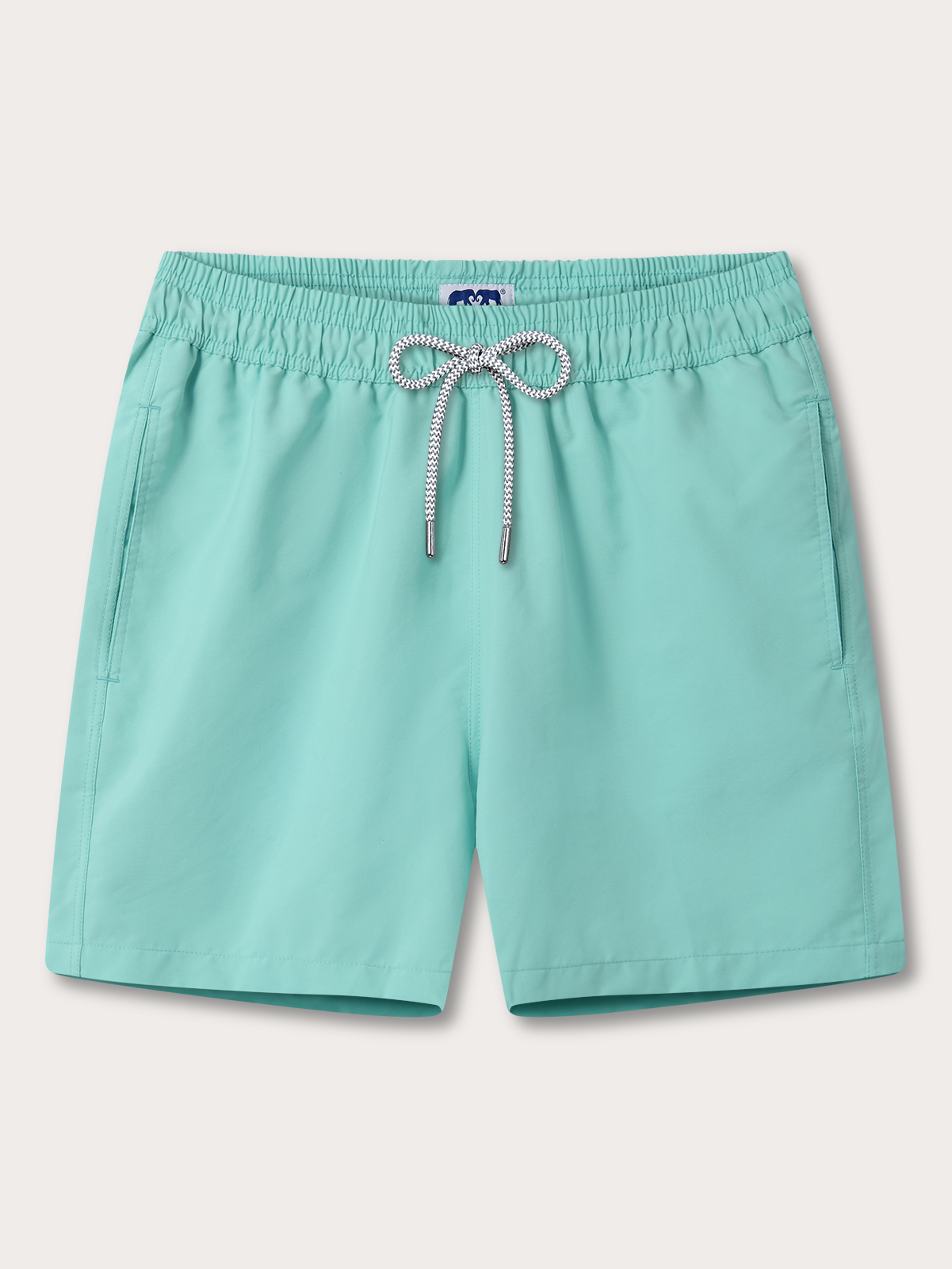 Turquoise shorts with a drawstring on a light beige background