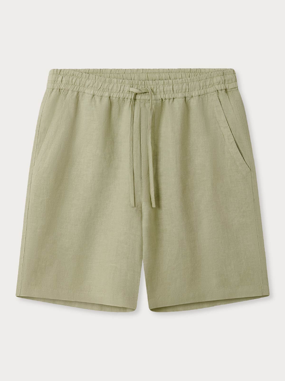 Green linen shorts with an elastic waistband on a white background