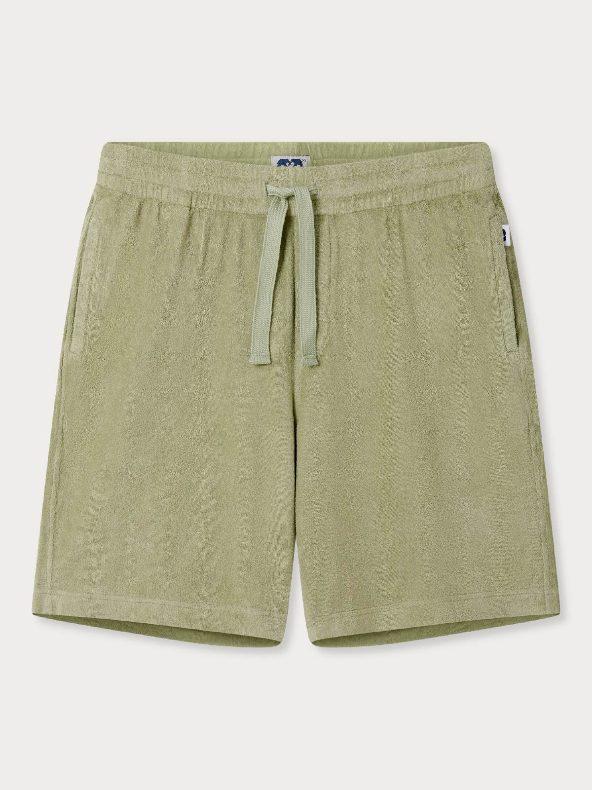 Green terry cloth shorts with a drawstring on a white background