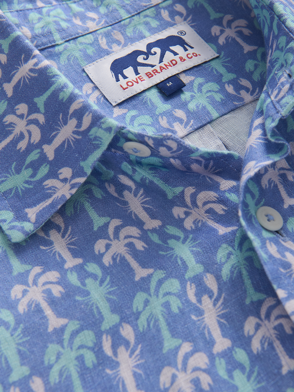 Close-up of a patterned blue shirt with a visible brand label