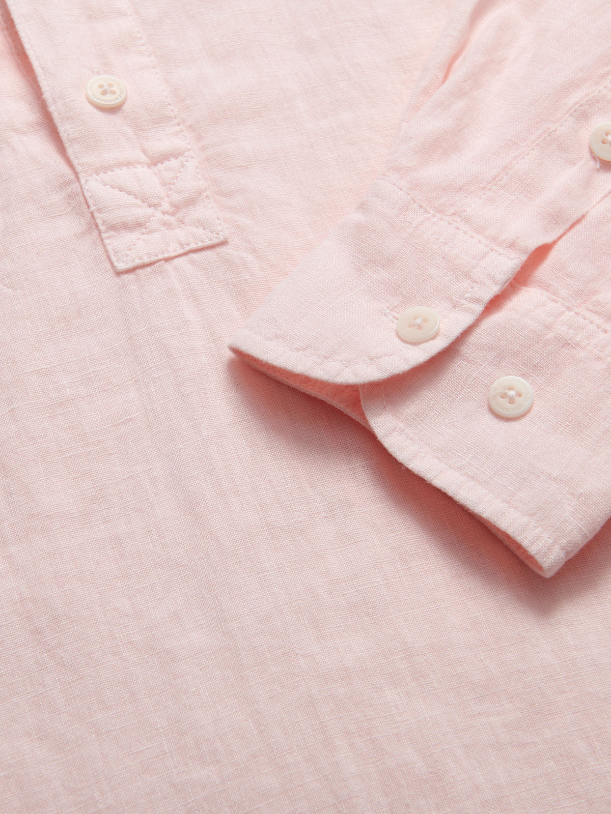 Mens Pastel Pink Hoffman Linen Shirt detailed view. Close-up of mens linen shirt with corozo nut button cuffs.