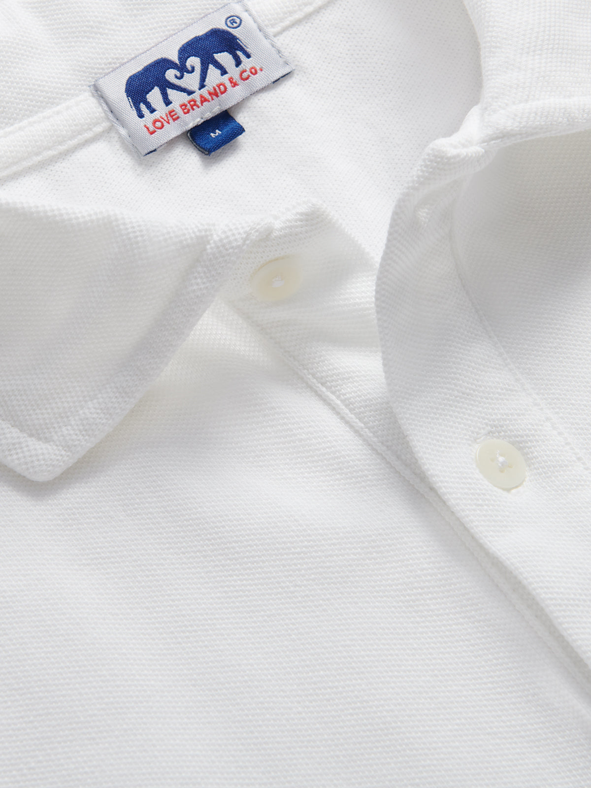 close-up of mens white polo shirt by love brand