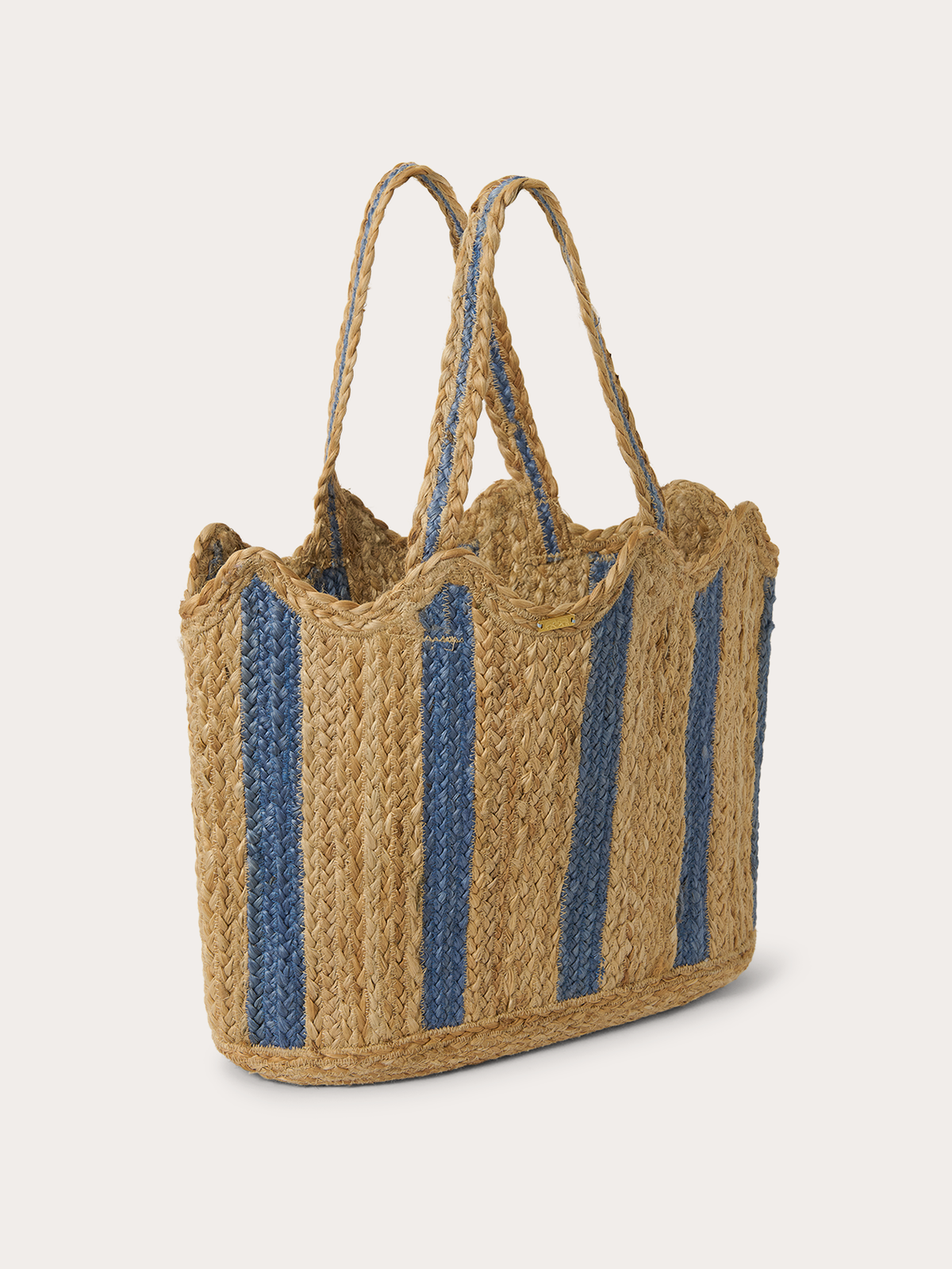 A woven straw tote bag with vertical blue stripes and long shoulder straps, photographed on a clean light grey background.