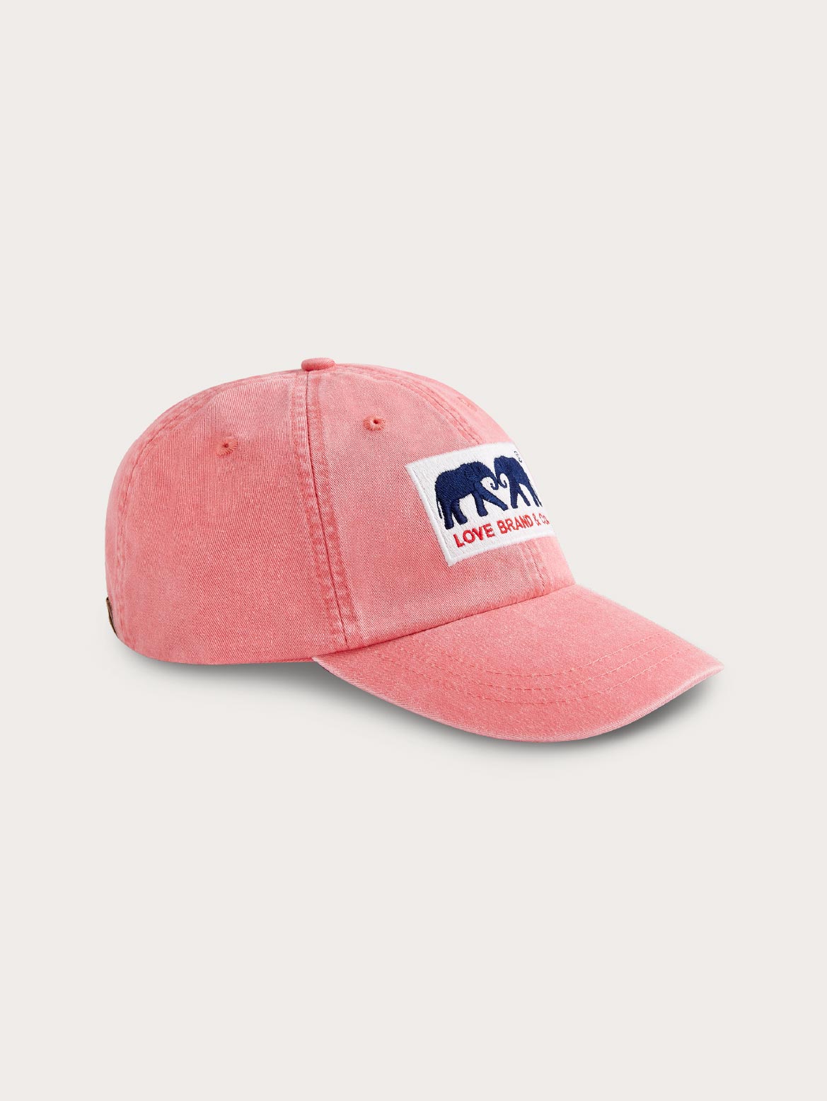 Pink cap with a logo on a light grey background
