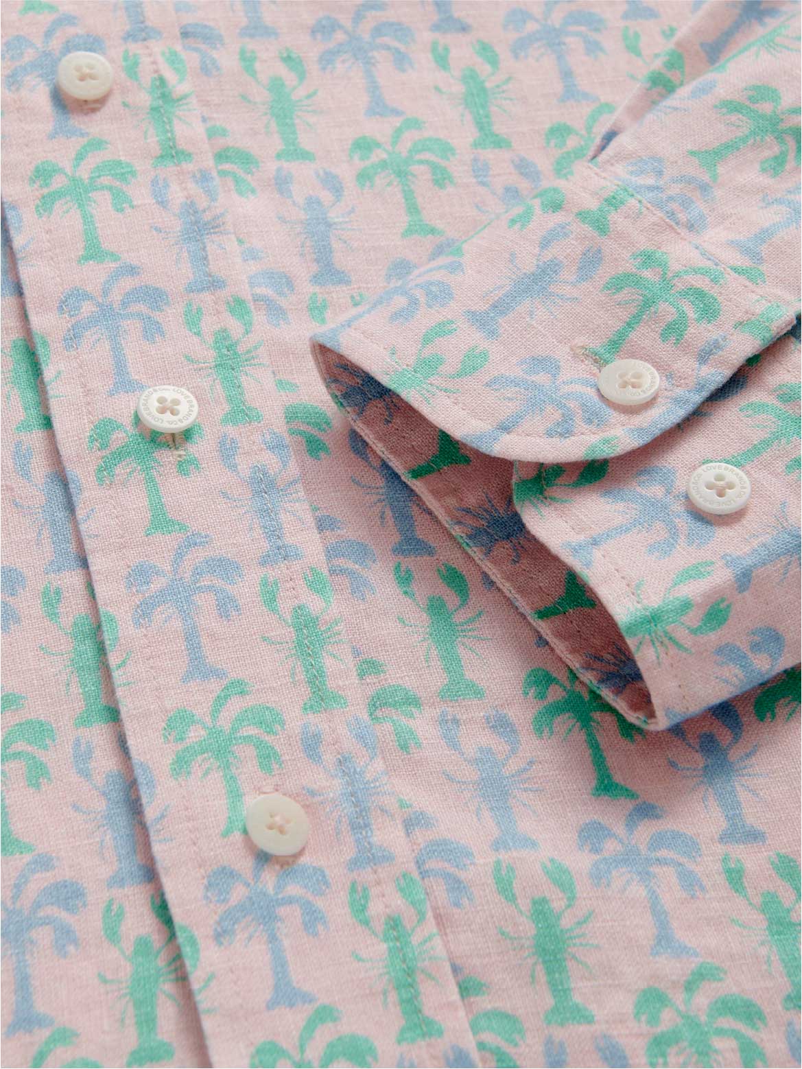 Pink linen shirt with green and blue palm tree pattern