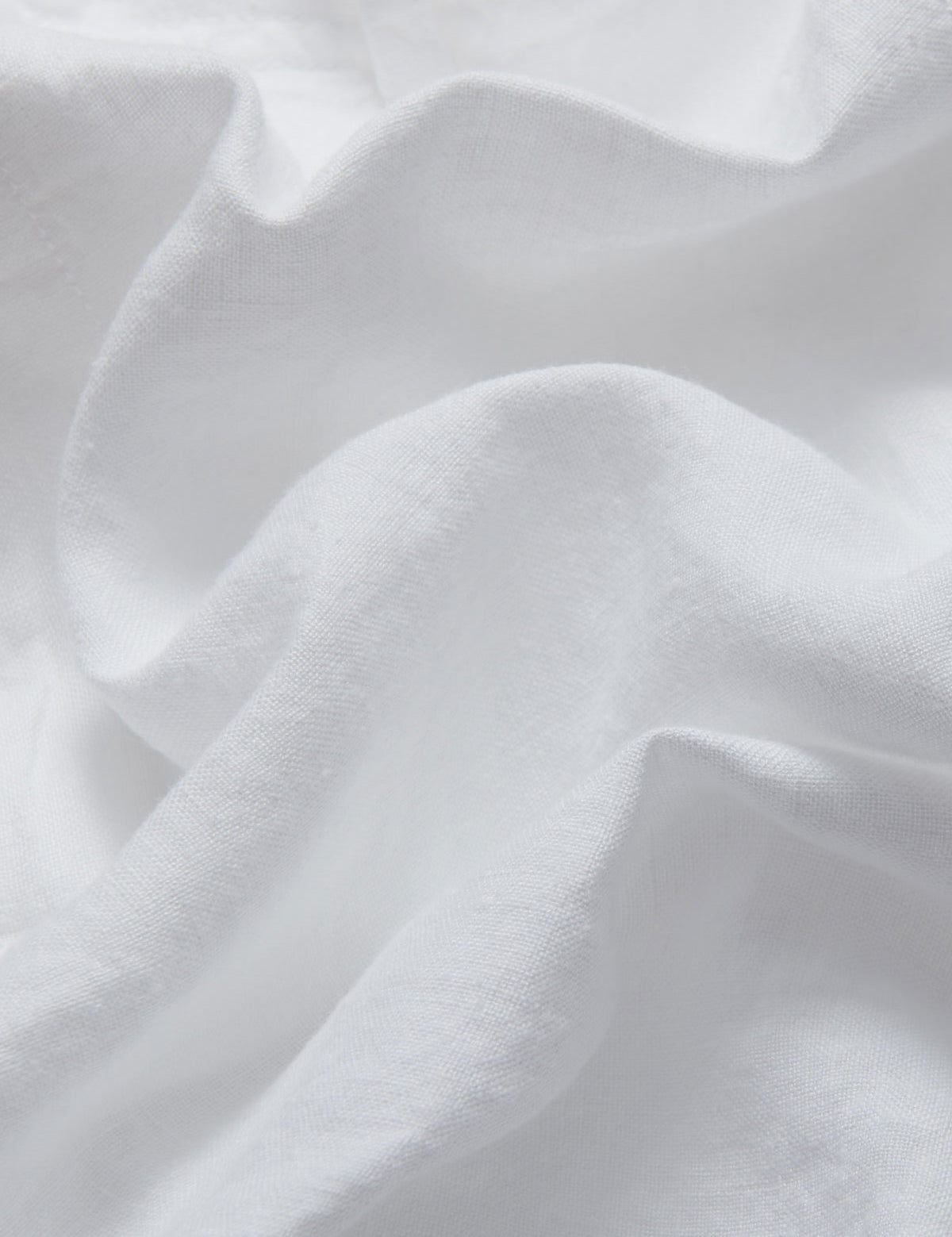 Close-up view of the fabric of LOVE BRAND & Co. Womens White Musha Linen Shorts. Crafted from 100% premium linen.