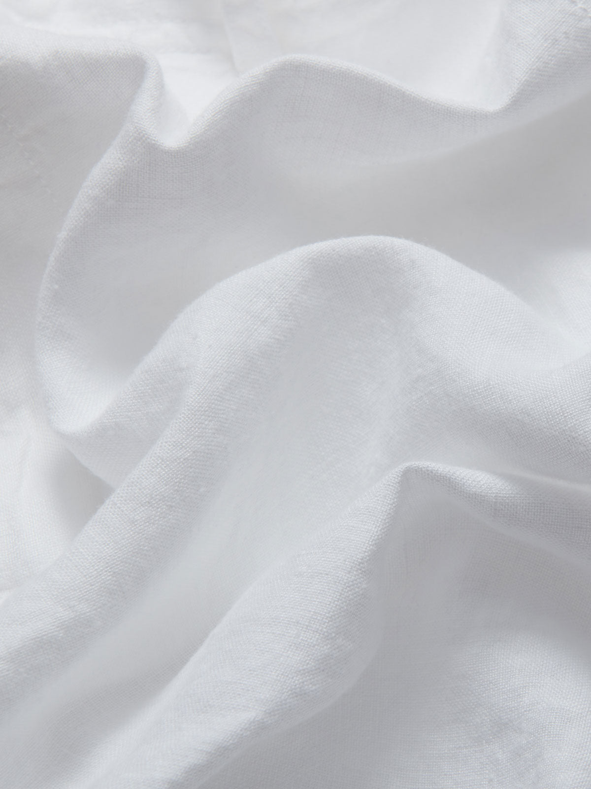 Close-up view of the fabric of LOVE BRAND & Co. Womens White Musha Linen Shorts. Crafted from 100% premium linen.