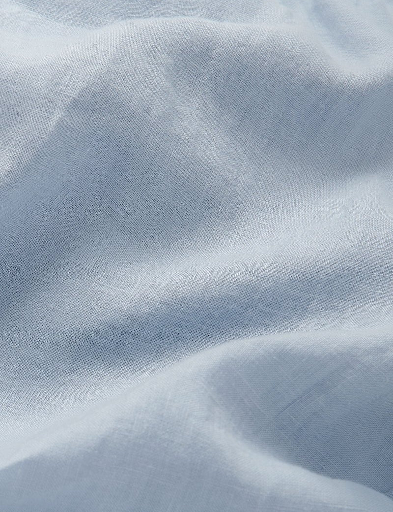 sky blue linen trousers mens close-up. Detailed view of sky blue linen fabric.