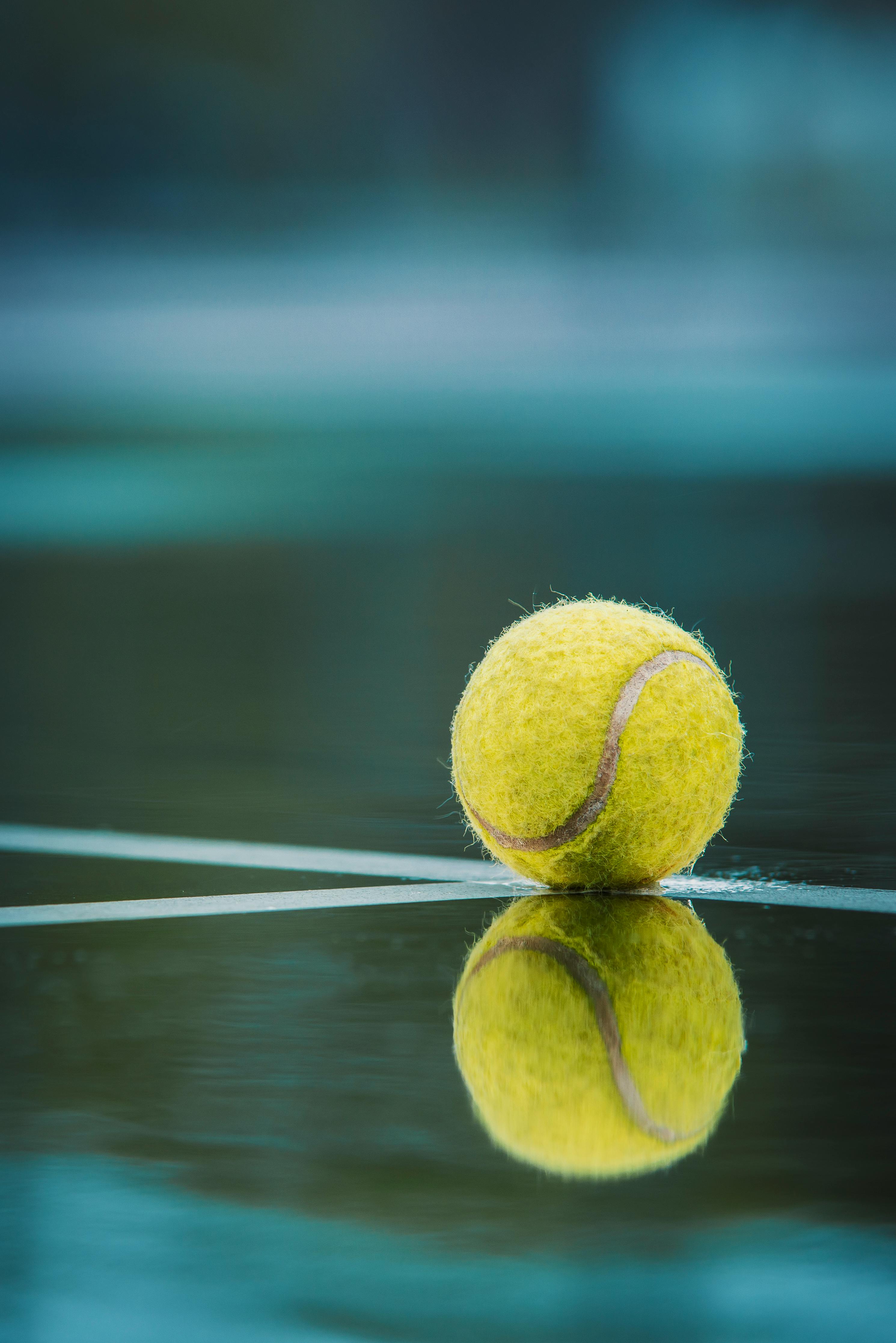 Tennis ball on a tennis court with a blurred background