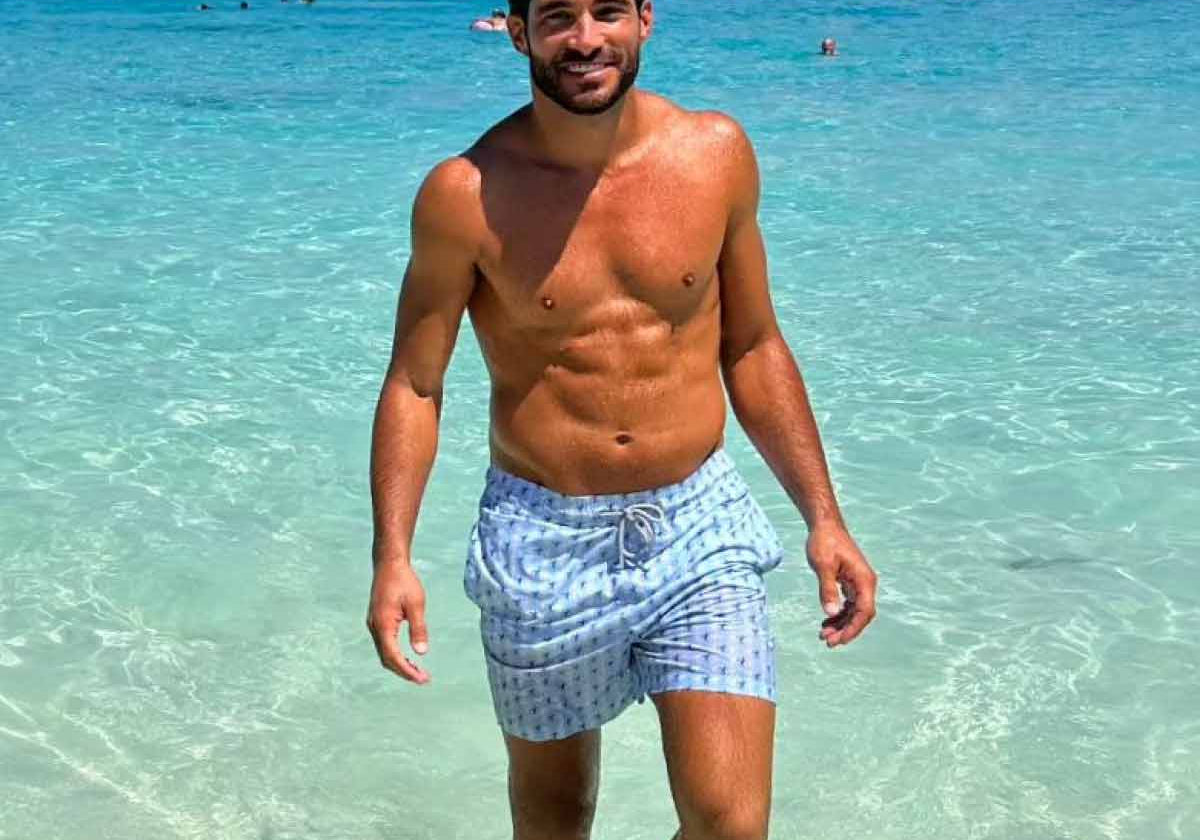 man wears blue swim shorts from beachwear brands uk love brand & co.