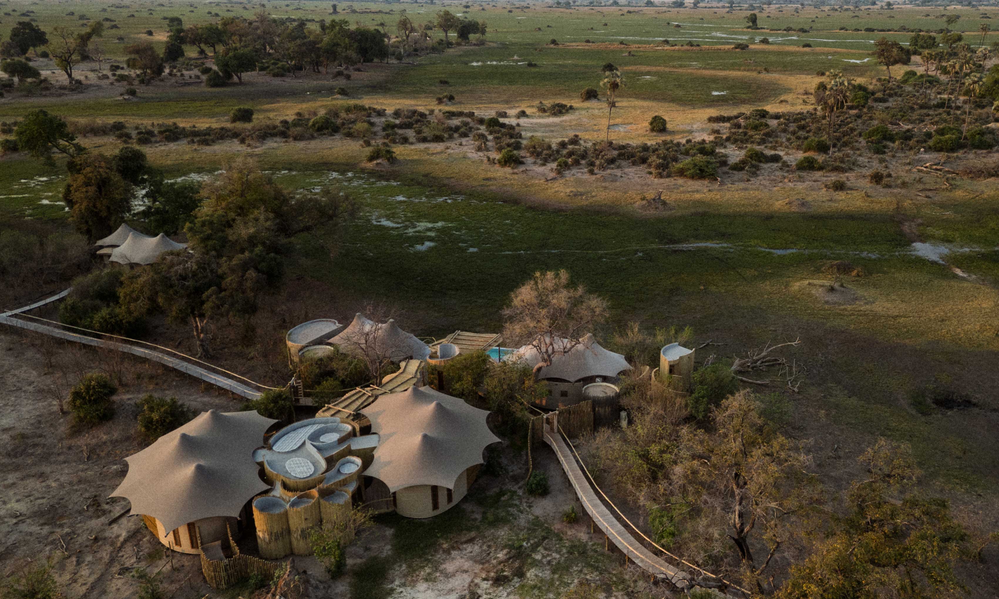 Aerial view of a safari lodge surrounded by natural landscape