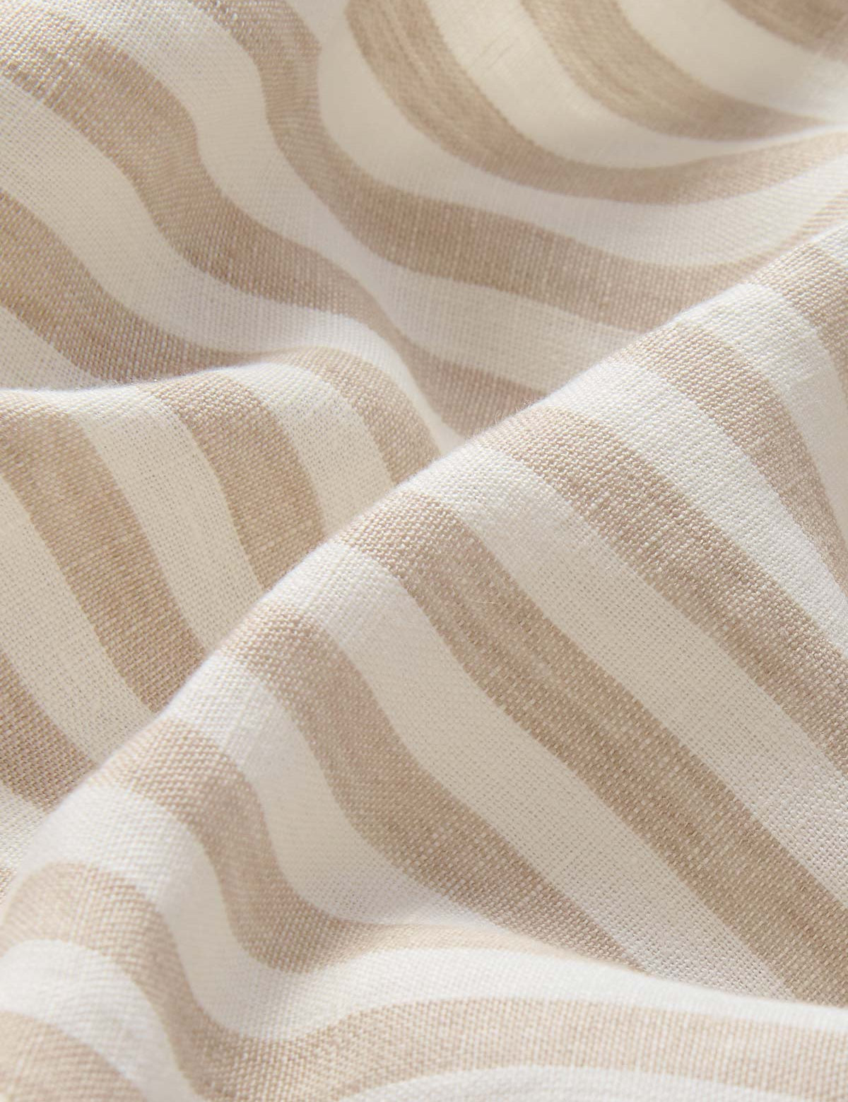 close-up fabric view of Womens Coconut Stripe Musha Linen Shorts. Brown and white linen shorts with a drawstring tie and elastic waist.