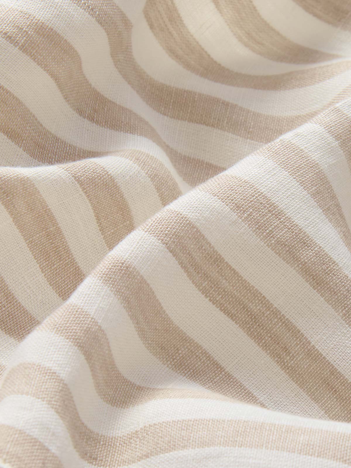 close-up fabric view of Womens Coconut Stripe Musha Linen Shorts. Brown and white linen shorts with a drawstring tie and elastic waist.