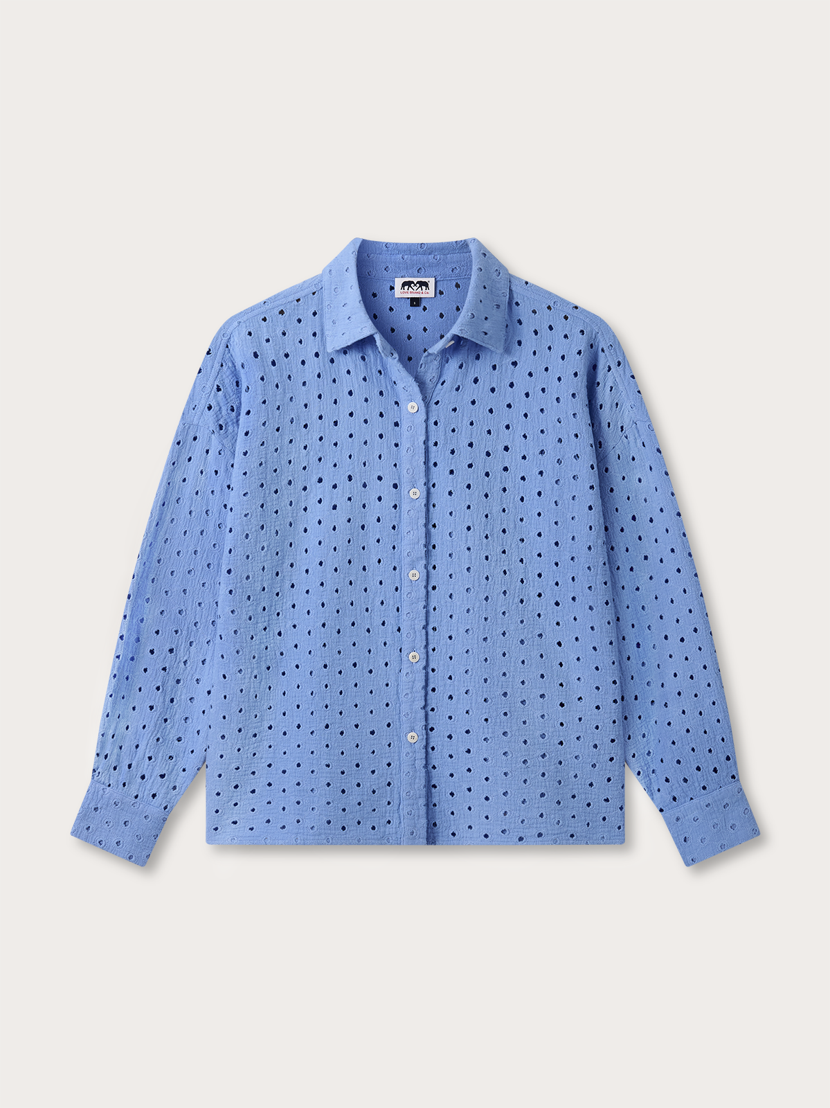 Blue eyelet shirt on a light grey background