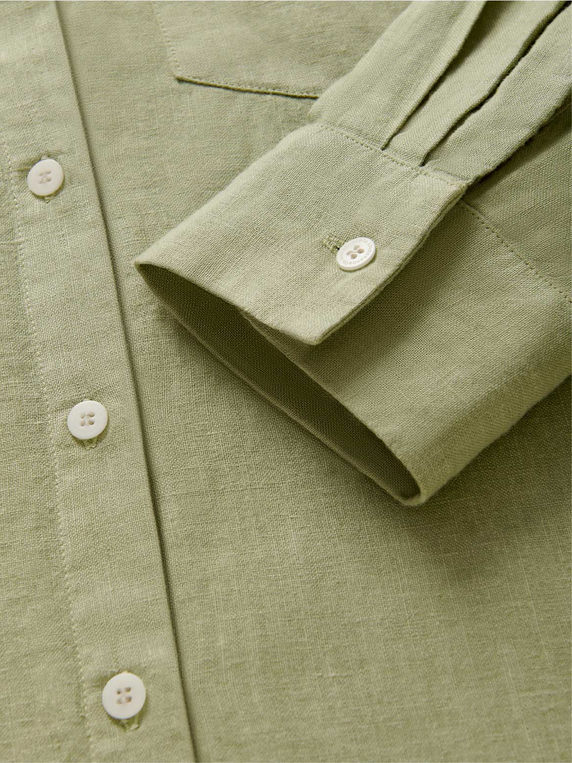 Detailed cuff view of womens green linen shirt